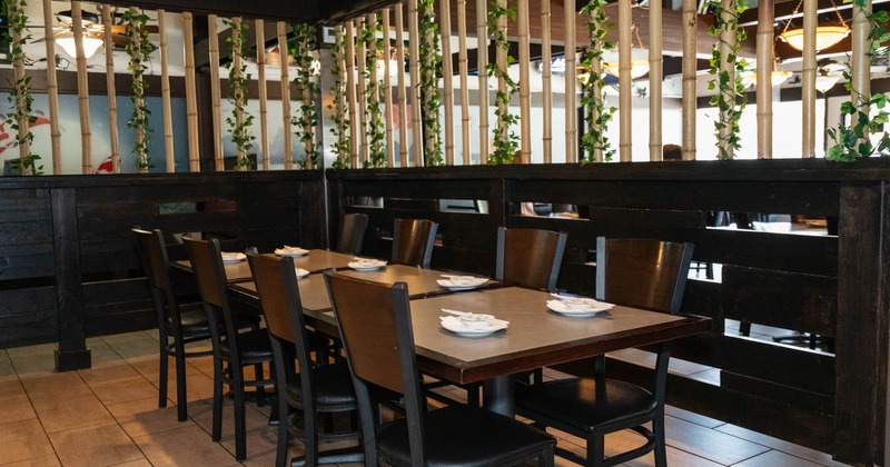A set dining table, the decor features bamboo stalks and dark wood paneling