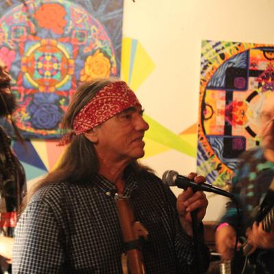 A singer on the stage, wall decorations behind.