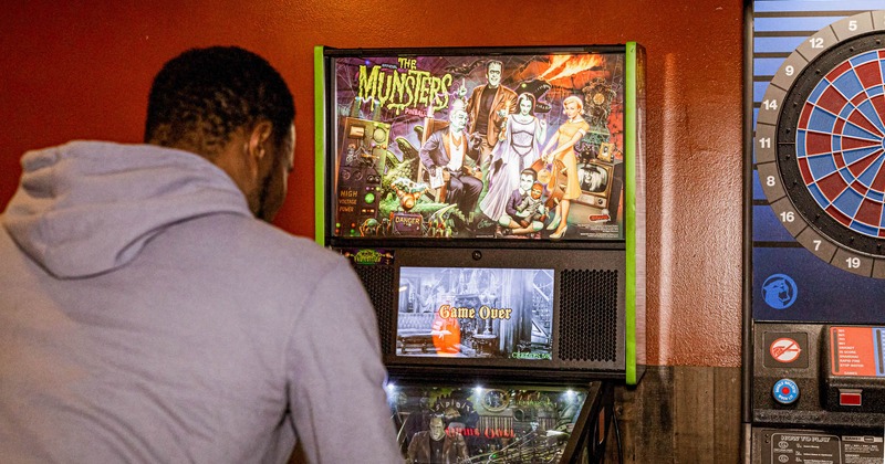 The guest is playing pinball