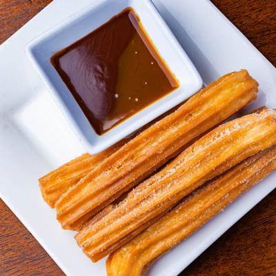 Churros served with chocolate sauce.