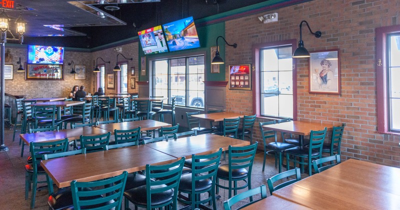 Spacious interior seating area, wooden tables and upholstered chairs