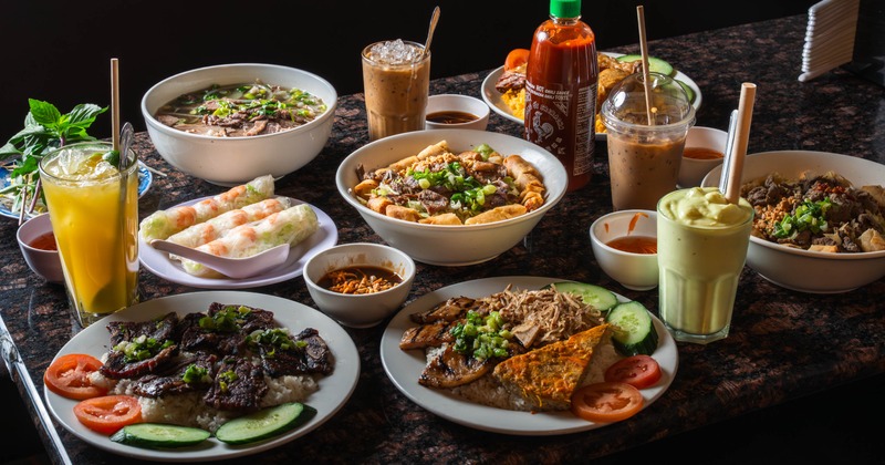 Assorted Vietnamese dishes and drinks arranged on a table