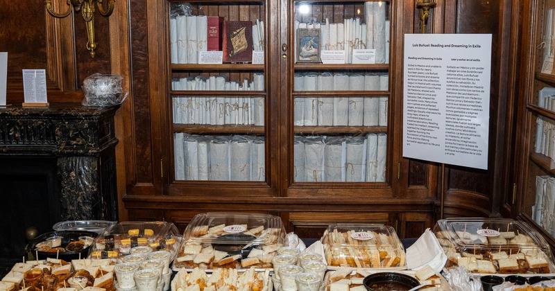 Sandwich catering trays with drinks in front of bookshelves