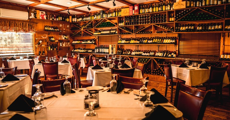 Interior, tables, chairs, bottles on shelves, clean glasses, lights