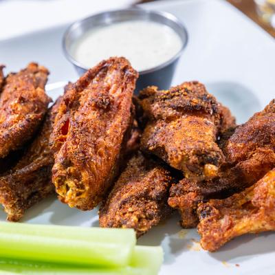 Chicken wings served with dipping sauce.