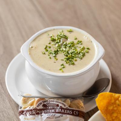 Clam chowder served with a package of crackers.
