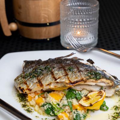 Grilled whole fish served over risotto
