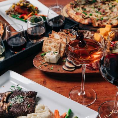 Assorted food plates and drinks on a table, close up.