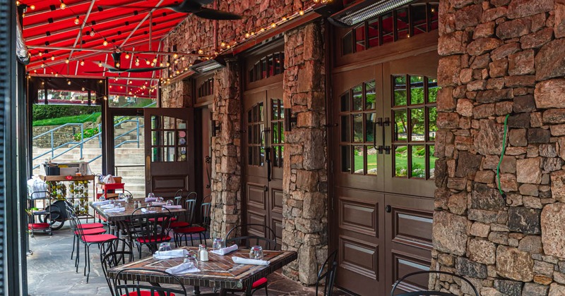 Exterior, set tables and seats under awning