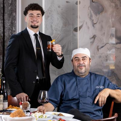 Restaurant owners posing for a picture.