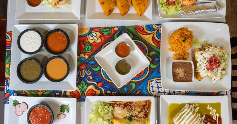 Assorted food plates arranged on a table, overhead view