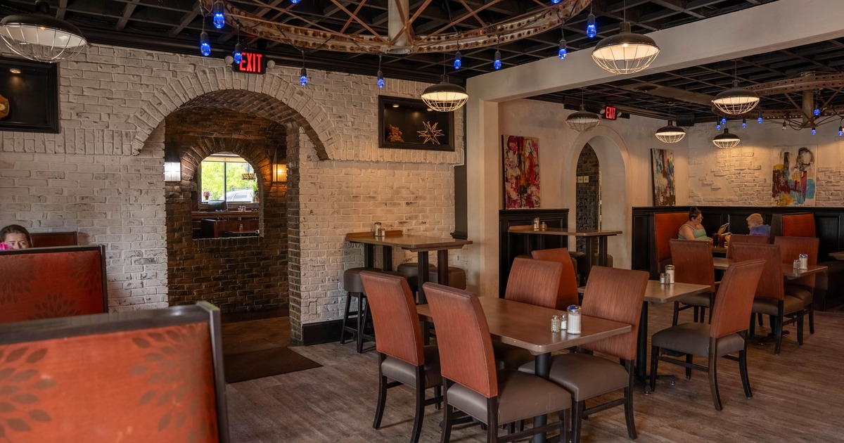 Interior, booths, wooden tables, architectural features, and colorful artwork on the walls