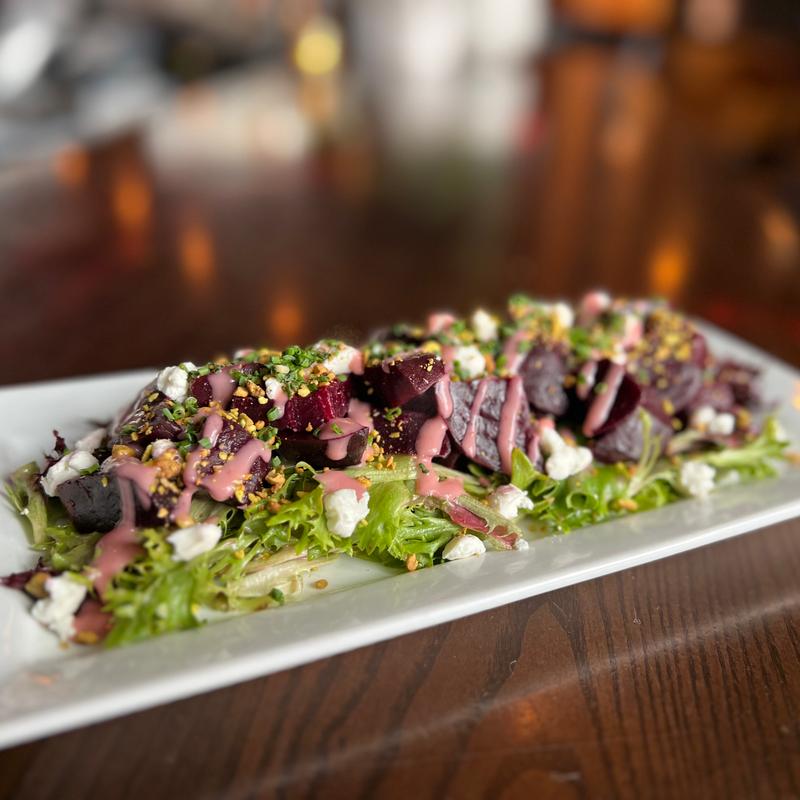 Organic red beets, goat cheese, pistachio, raspberry vinaigrette on a bed of field greens - GF photo