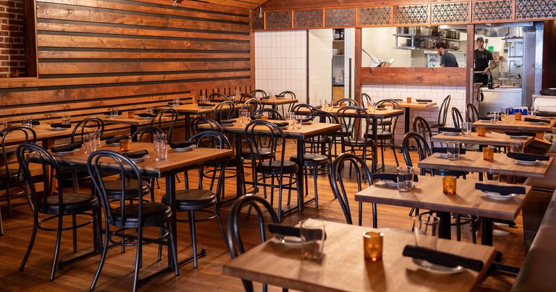 Interior, chairs and tables next to the brick wall