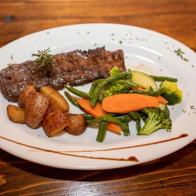 Skirt Steak served with roasted red potatoes and sauteed vegetables.