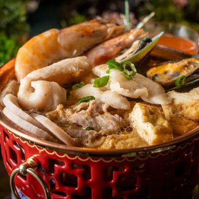Seafood hotpot with shrimp, mussels, tofu, and sliced fish.