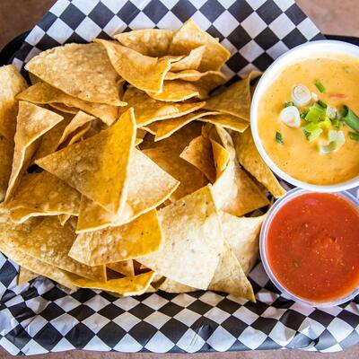 Basket of Chips with housemade queso cheese dip and salsa