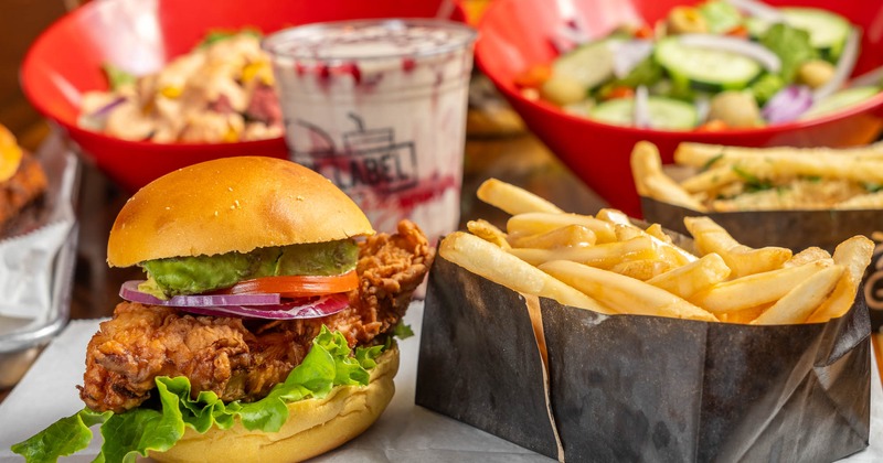Orange label deep fried chicken sandwich with fries on the side