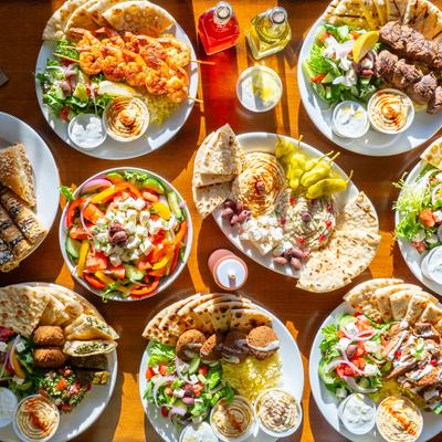 A table spread with assorted food plates, overhead view.