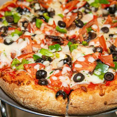 Veggie pizza, with tomatoes, cheese, green peppers, black olives, and mushrooms.