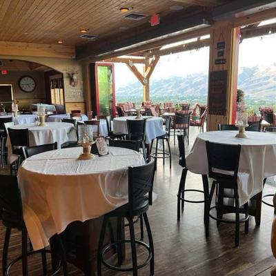 Interior, round dining tables with table cloths.