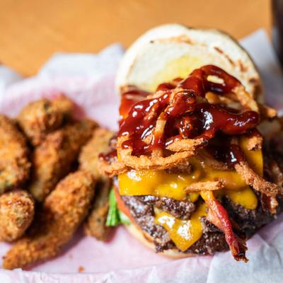 Burger with Bacon, cheddar, onion straws, BBQ sauce, side of Cajun Fries.