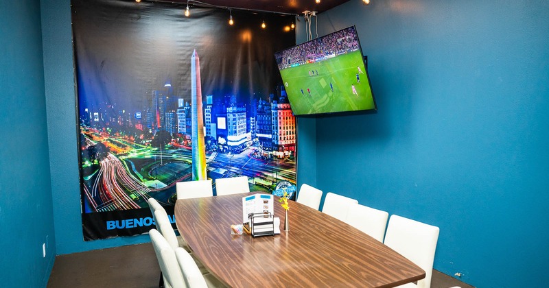 Interior, table in corner, big TV on the wall