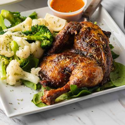 Half roasted lemon chicken, served, side view, closeup