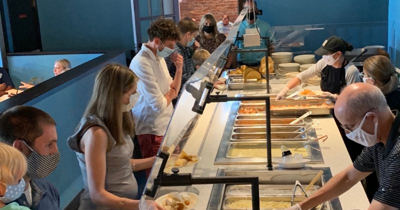 Staff members serving food for guests