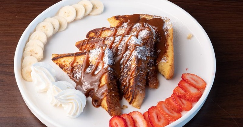 Nutella French Toast garnished with bananas, strawberries, and whipped cream