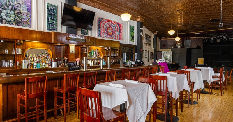 Interior, bar and dining tables, wall art and TV above the back bar