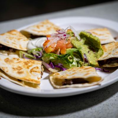 Quesadillas served with guacamole, sour cream and salad.
