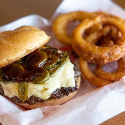 Cheeseburger, with bacon, jalapenos, grilled onions, BBQ sauce, and a side of onion rings