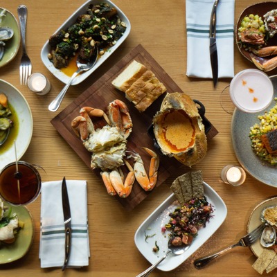 Table set and filled with a varied of dishes.