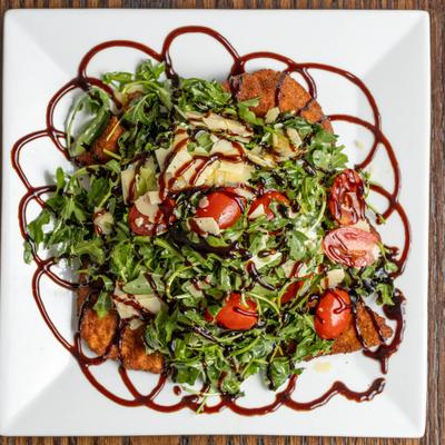 Breaded chicken cutlet, with arugula, grape tomatoes, parmesan, and balsamic.
