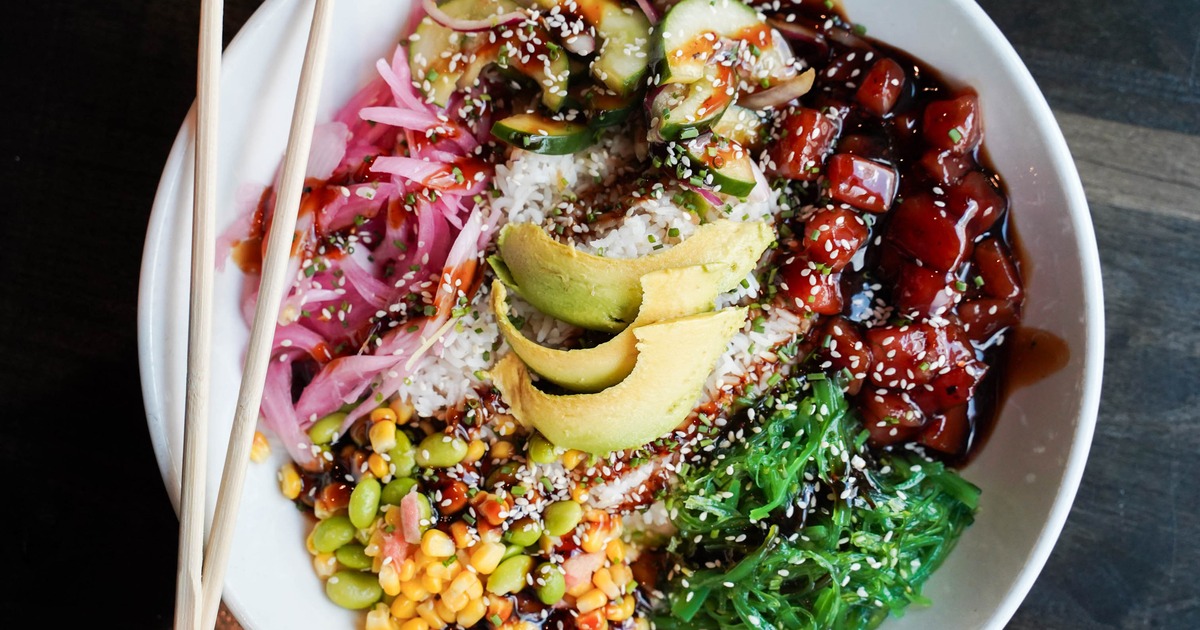 Colorful poke bowl with avocado slices