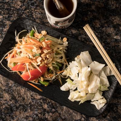 Papaya Salad with peanuts and sauce on the side.