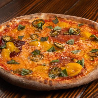 The Peach Pizza with salami, fresh peaches, jalapenos, honey and basil.