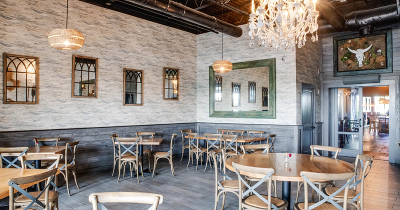 Interior, tables ready for guest, walls decorated with mirrors