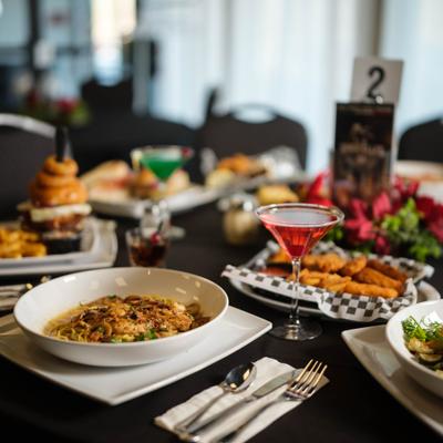 Variety of dishes served on the table with cocktails.