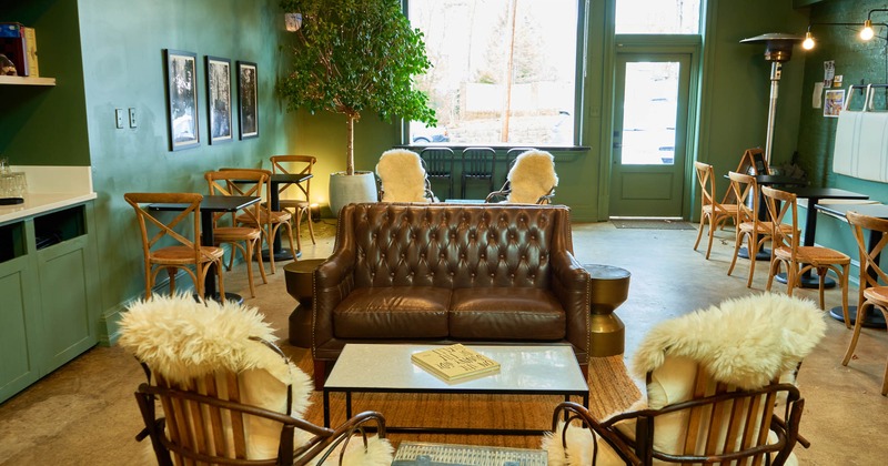 Interior, brown leather sofa, tables and chairs lined up