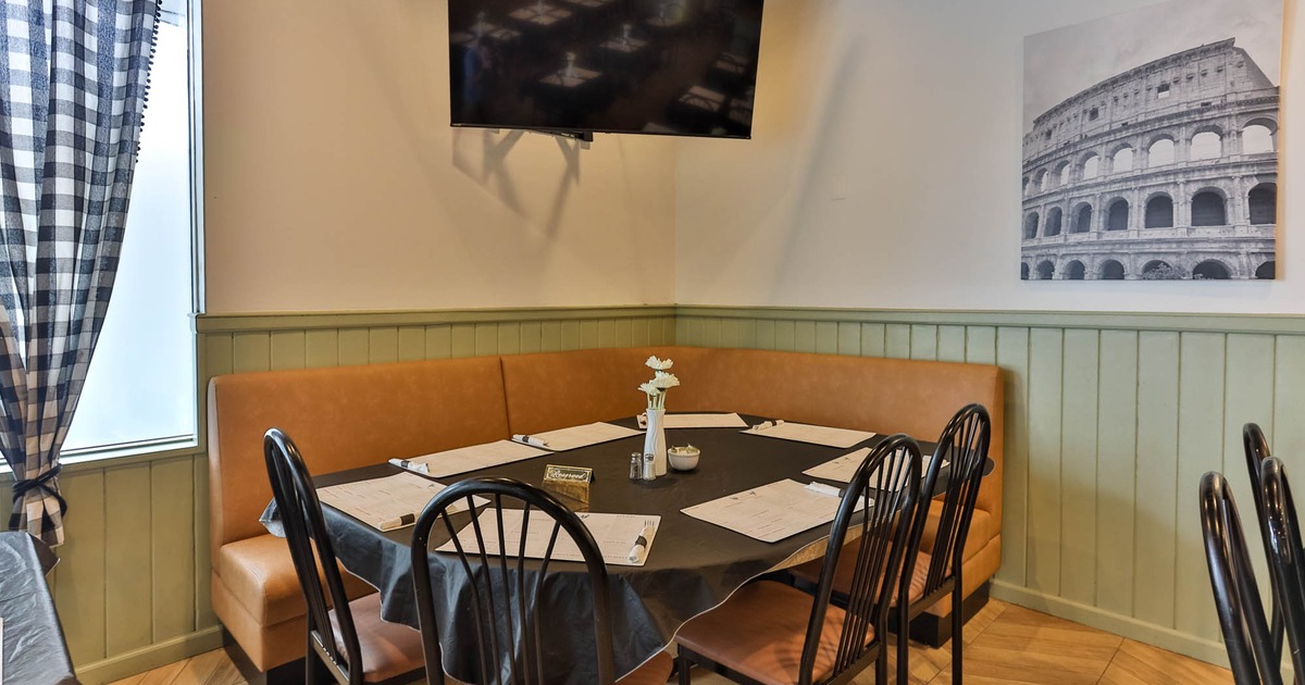 Interior, table, chairs and an orange-brown cushioned corner bench