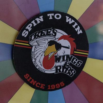 Colorful spin wheel with a restaurant signage, close-up.