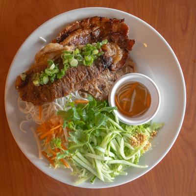 Vietnamese grilled pork and beef with rice noodles, fresh vegetables, and dipping sauce.