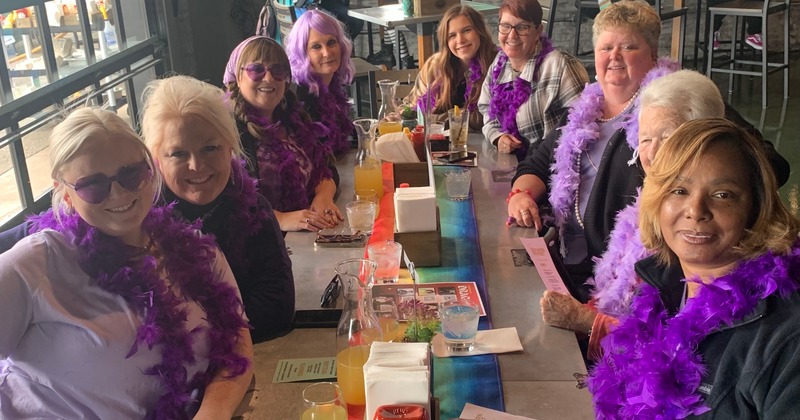 A group of guests sitting together at a table, enjoying each other's company