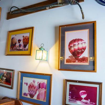 Colorful hot air balloon photos on a wall.