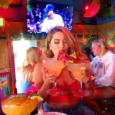 A person drinking cocktails