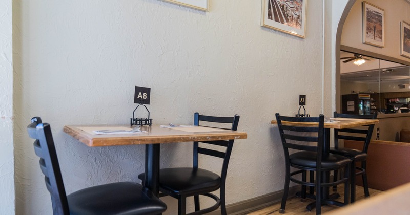 Two tables for two placed against the wall