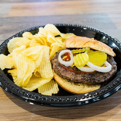 Hamburger served with potato chips.