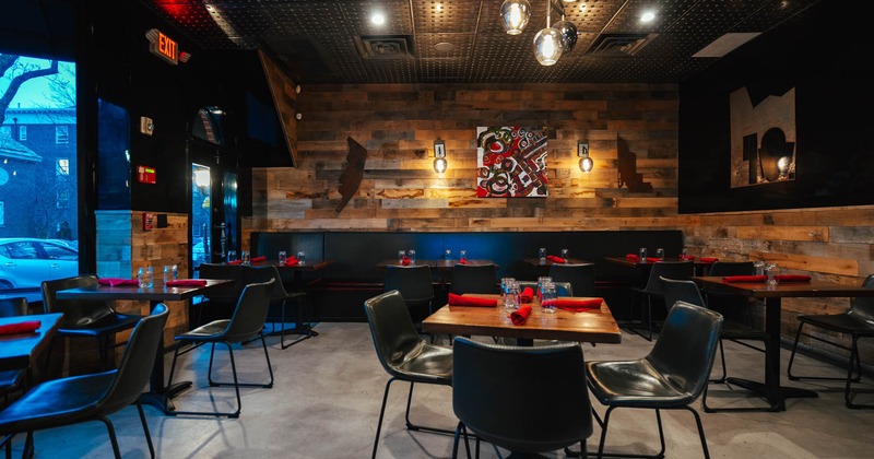 Interior, dining area, tables ready for guests, long banquette bench with chairs and tables